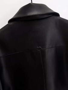 Close-up of the back seam and premium leather texture of a black short jacket