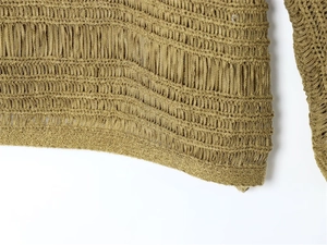 Detailed close-up of hollow knit texture and ribbed hem on this olive green knitted top