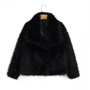 Chic black faux fur jacket with wide lapels on a wooden hanger against white backdrop