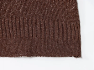 Close-up of brown ribbed knit fabric with metallic glitter yarn and fine texture