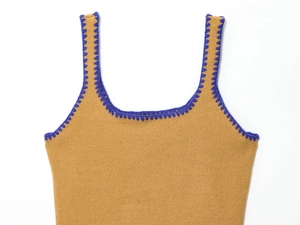 Close-up of camel knit camisole with blue scalloped embroidery and thick rib texture