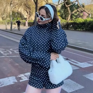 Chic women's black and white polka dot jacket and shorts set with puff sleeves