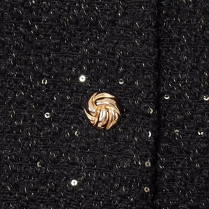 Tweed jacket detail with black woven fabric, gold sequins and vintage metal button