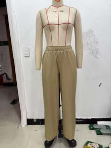Elastic high-waisted wide-leg trousers in khaki fabric on a mannequin display