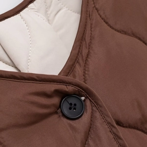Brown quilted jacket with wave patterns and button closure detail for women