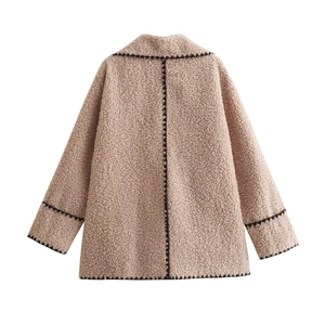 Women's beige sherpa jacket featuring black contrast wavy embroidery on the back
