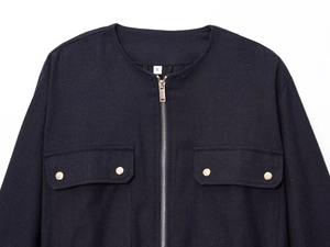 Detailed view of a navy linen-blend safari jacket with gold snaps and metal zipper