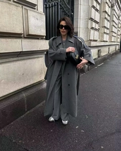 Outdoor shot of a grey wool coat with double-breasted buttons and matching belt