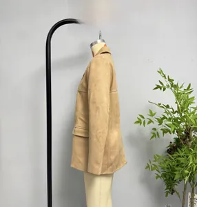Detailed view of the tan faux suede jacket featuring a wide notched lapel and flap pocket