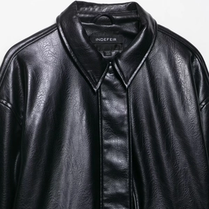 Vintage black faux leather bomber jacket for women featuring a classic collar and texture