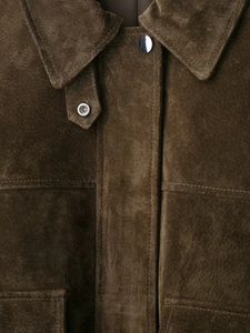 Detail of dark brown faux leather pilot jacket showing silver snap buttons and collar texture