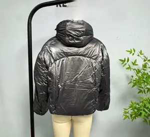 Detail of metallic silver hooded puffer jacket with quilted padding and back view