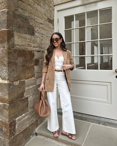 Chic women's tan faux suede longline blazer with white wide-leg trousers and accessories