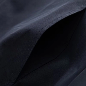 Detailed view of side pocket stitching on navy blue fashionable jacket for women