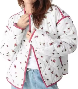 Detail of floral quilted cotton jacket with pink trim and snap button closure
