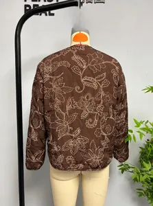 Rear view of brown quilted jacket featuring beige floral embroidery and vintage patterns