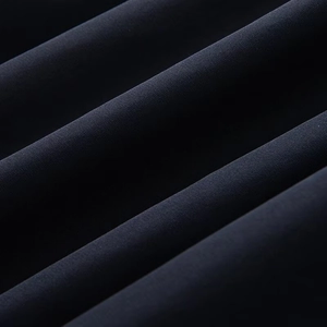 Detailed macro view of dark blue twill fabric texture with elegant sheen and folds