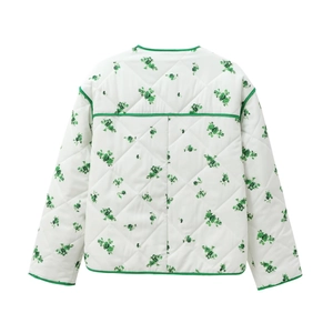 Detailed back view of white quilted jacket with green floral print and contrast piping