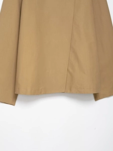 Close-up of khaki short jacket showing high-quality stitching and smooth cotton fabric