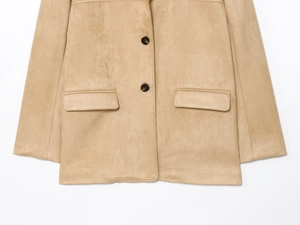 Detail of camel faux suede jacket featuring dark marble buttons and flap pockets