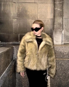 Close-up of oversized lapel on faux fur jacket with heart-shaped sunglasses