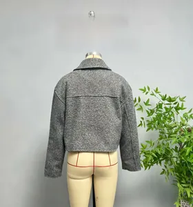 Close-up of gray tweed short jacket showing texture, lapel collar, and structured back seams