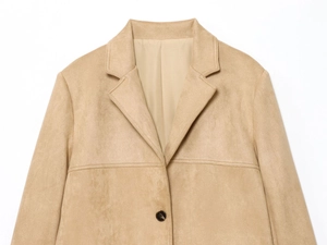 Detailed close-up of light camel faux suede blazer featuring notched lapels and single button