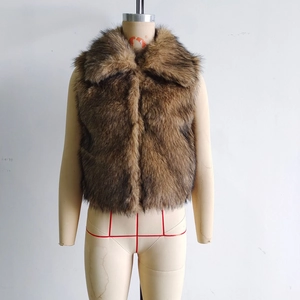 Close-up of a dark brown faux fur vest with thick texture and wide lapels on display