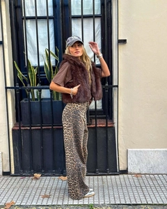 Street style view of brown faux fur vest paired with trendy leopard print wide-leg pants
