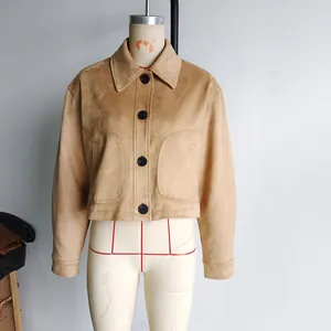 Close-up of camel faux suede jacket featuring large pockets and black buttons on a mannequin