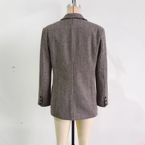 Detail view of the classic houndstooth pattern and back tailoring of this blazer