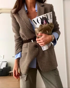 Detail of classic brown houndstooth blazer with single-breasted buttons and notched lapel
