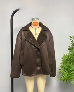 Detail of faux shearling collar and suede texture on oversized brown winter jacket