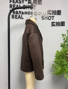 Detailed side view of a brown faux suede winter jacket with dark brown faux fur lining