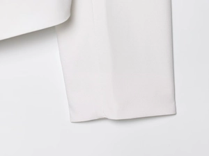 Close-up of white V-neck blazer showing high-quality fabric texture and neat stitching