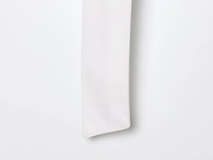 Close-up detail of the white fabric belt showing fine plain weave texture and stitching