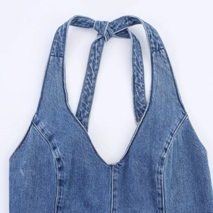 Deep V-neck denim halter dress in blue washed fabric with tie-up back and princess seams