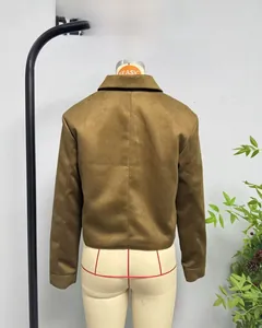 Detail view of the brown faux suede cropped jacket with notched collar and back seam
