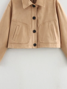 Detailed view of camel faux suede jacket featuring large utility pockets and dark buttons