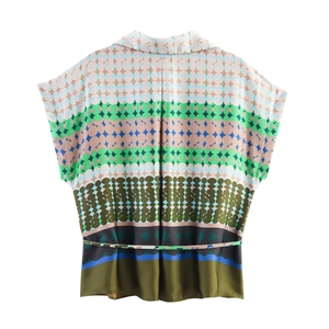 Back view of a satin short-sleeved shirt featuring a vibrant geometric print and a slim belt