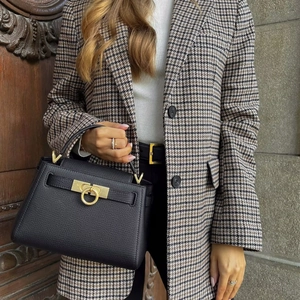 Classic black pebbled leather trapeze handbag with golden Gancini style ring hardware
