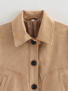 Detail of camel faux suede jacket featuring large black buttons and neat stitching