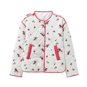 Women's white floral quilted jacket with pink trim and snap buttons in a flat lay view