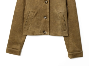 Close-up of brown suede jacket showing textured fabric and round button details