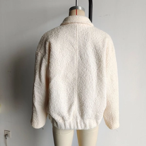 Rear view of cream faux shearling jacket with turn-down collar and textured finish