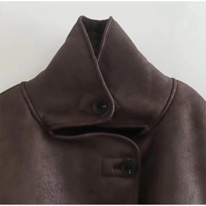 Detail of high-quality brown suede texture and plush faux fur lining on winter coat