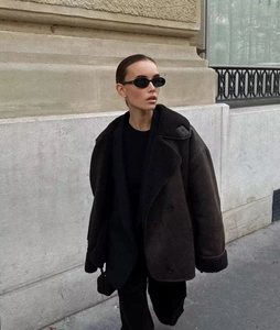 Detail of faux suede aviator jacket featuring thick black shearling collar and cuffs