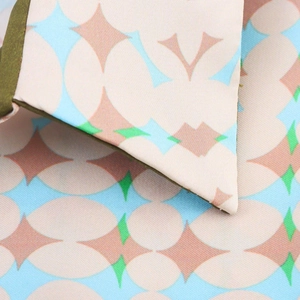 Macro shot of geometric print satin fabric showing premium stitching and collar detail