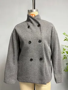 Detail of high collar and double-breasted black buttons on dark grey wool coat