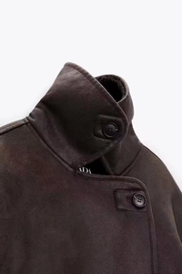 Detail of ADA brand label on the inner collar of a warm faux suede shearling jacket